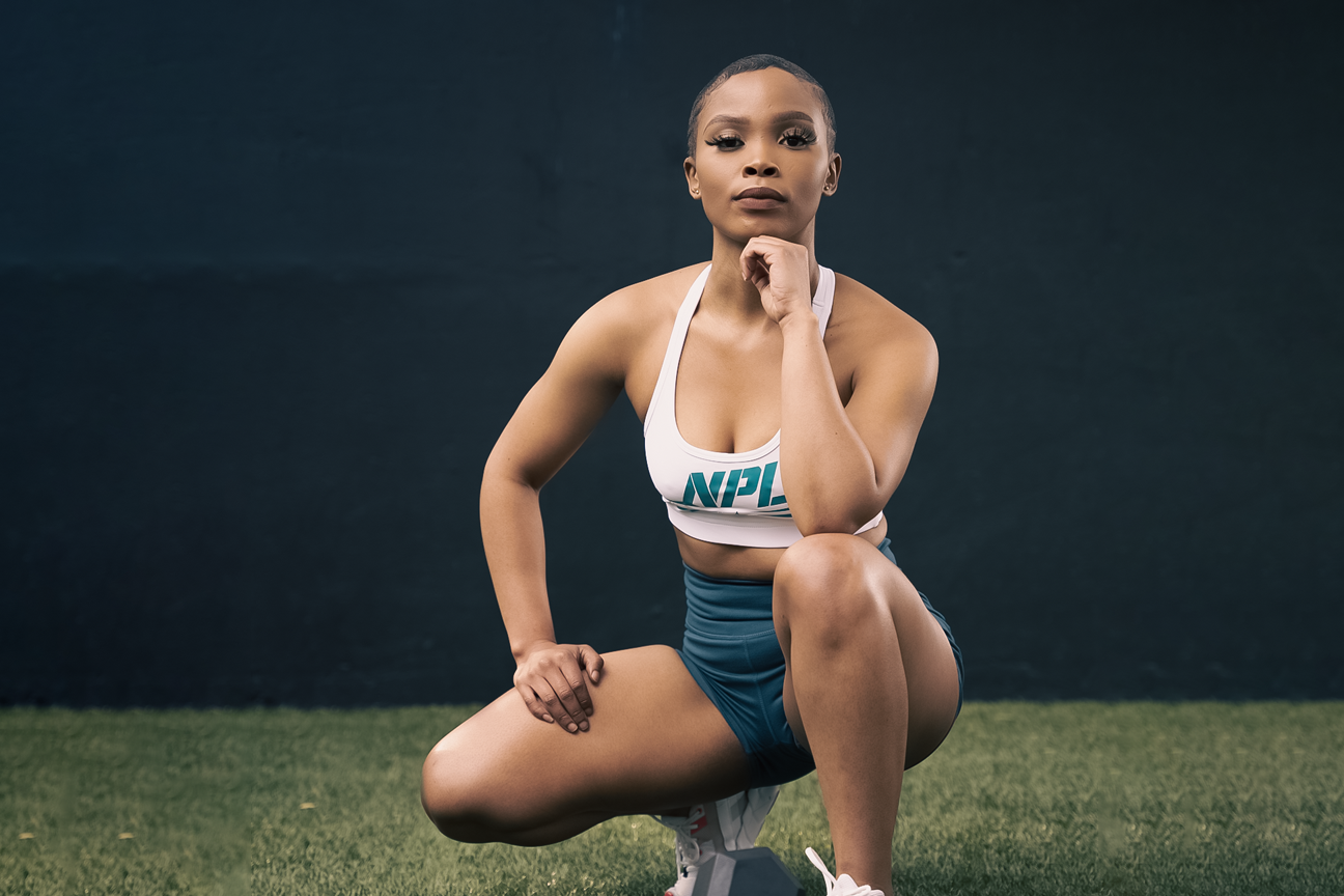 NPL athlete in a kneeling pose with one hand on her thigh, blog discusses fat loss myths and facts